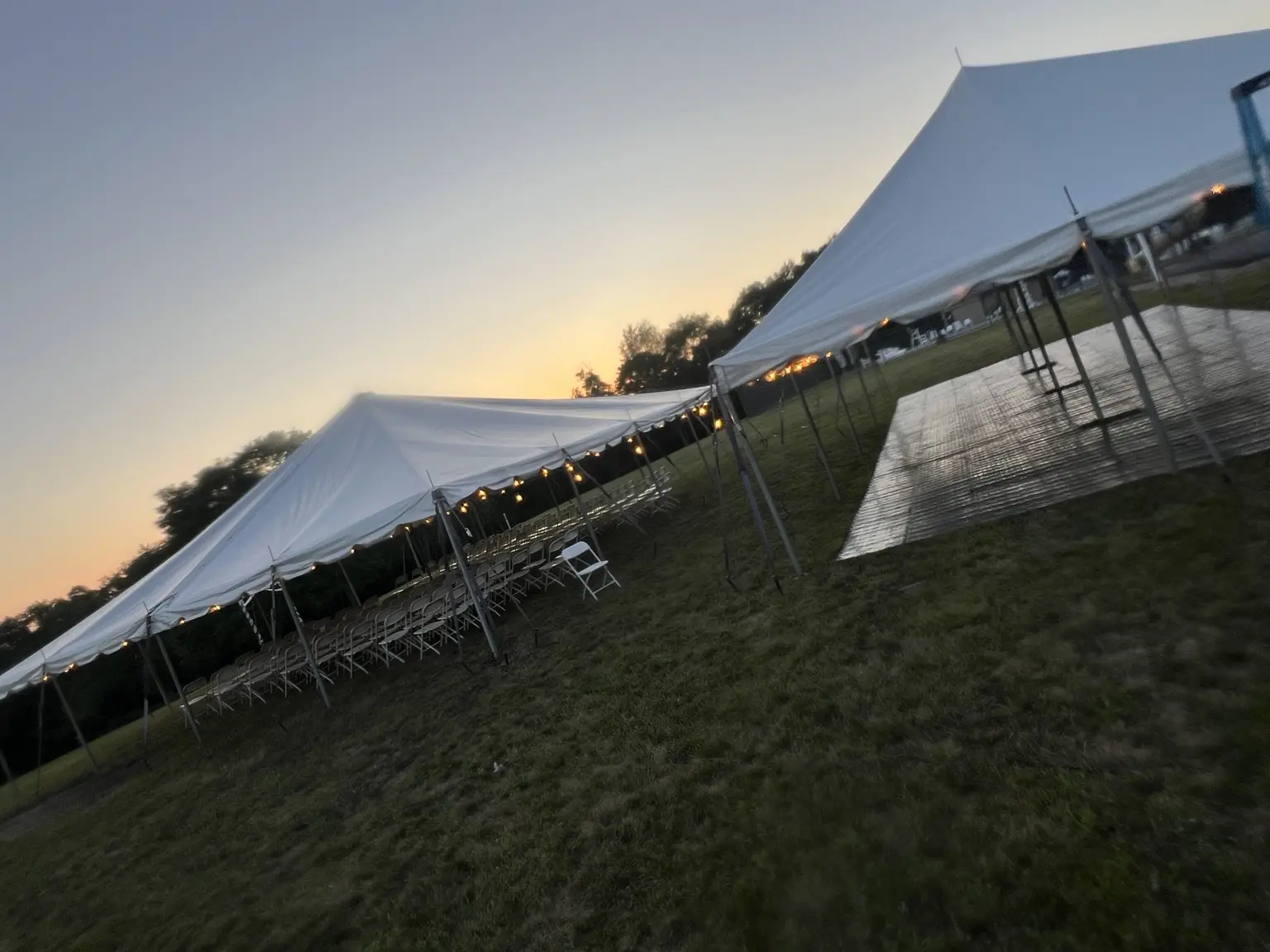 Riverstone event tent lit at sunset